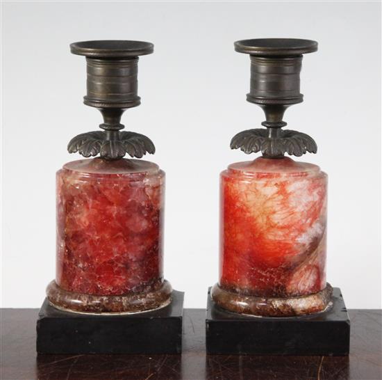 A pair of Regency bronze and red fluorospar / Blue John mounted candlesticks, 6.25in.